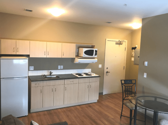 Kitchen with fridge, stove and microwave