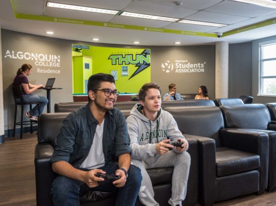 two students playing a game in the lounge