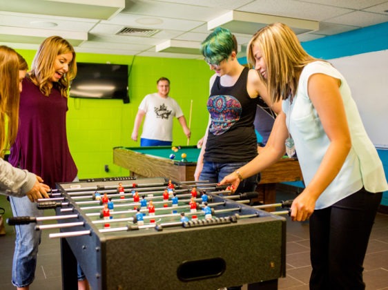 students playing fuseball in games room