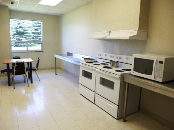 common kitchen with oven microwave and tables