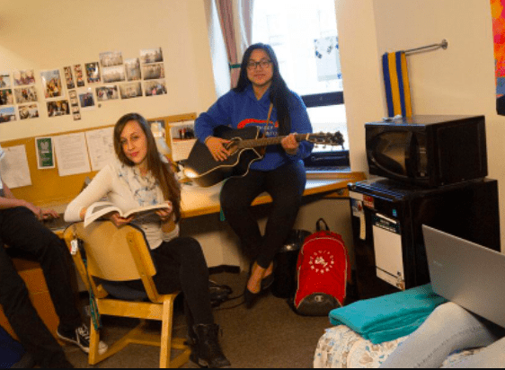 students sitting in residence room