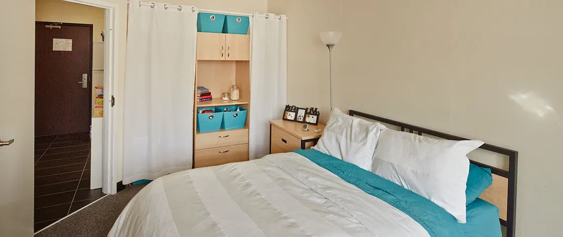 Student residence bedroom with bed and nightstand