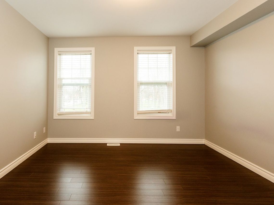 large unfurnished room with two windows