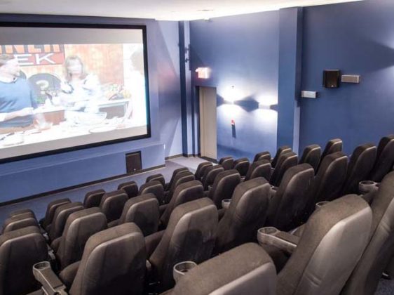 theatre room with large screen and chairs