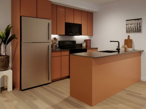 Modern, clean line kitchen with terracotta color cabinetry, large tropical plant, and breakfast bar with sink.